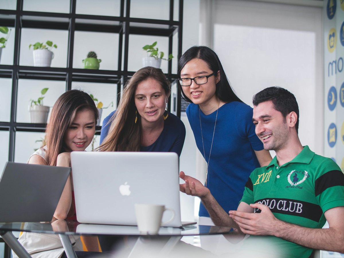 Team reviewing a web portal on a laptop